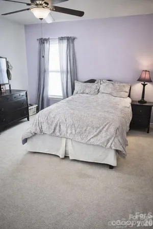a bed room with a bed and a chandelier