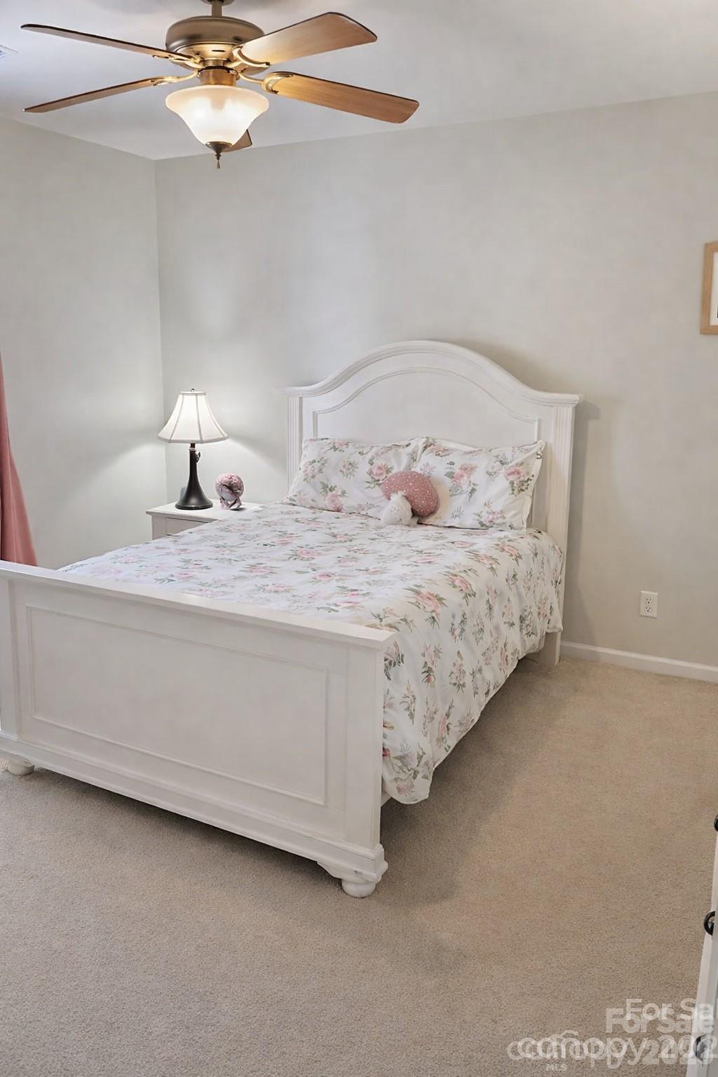 8006 Fine Robe Drive Indian Trail, NC 28079 - Photo 19 of 25 a bed room with a bed and a chandelier