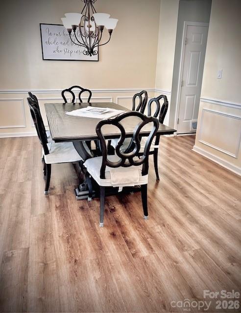 8006 Fine Robe Drive Indian Trail, NC 28079 - Photo 7 of 25 a view of a dining room with furniture and wooden floor
