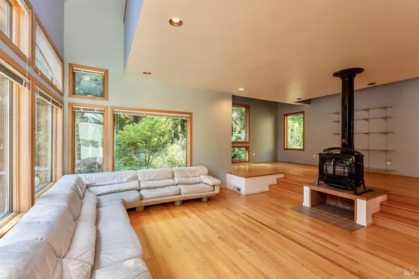a bedroom with furniture and a large window