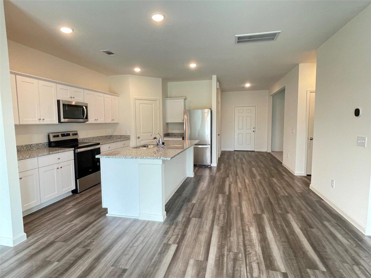 3122 Diamond Vw Lane Angleton, TX 77515 - Photo 2 of 10 a large kitchen with a center island wooden floor stainless steel appliances and cabinets