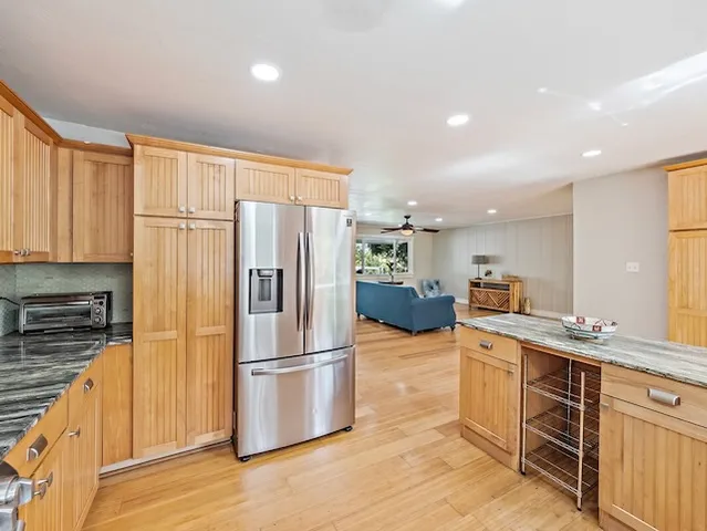 a kitchen with stainless steel appliances a refrigerator sink and microwave