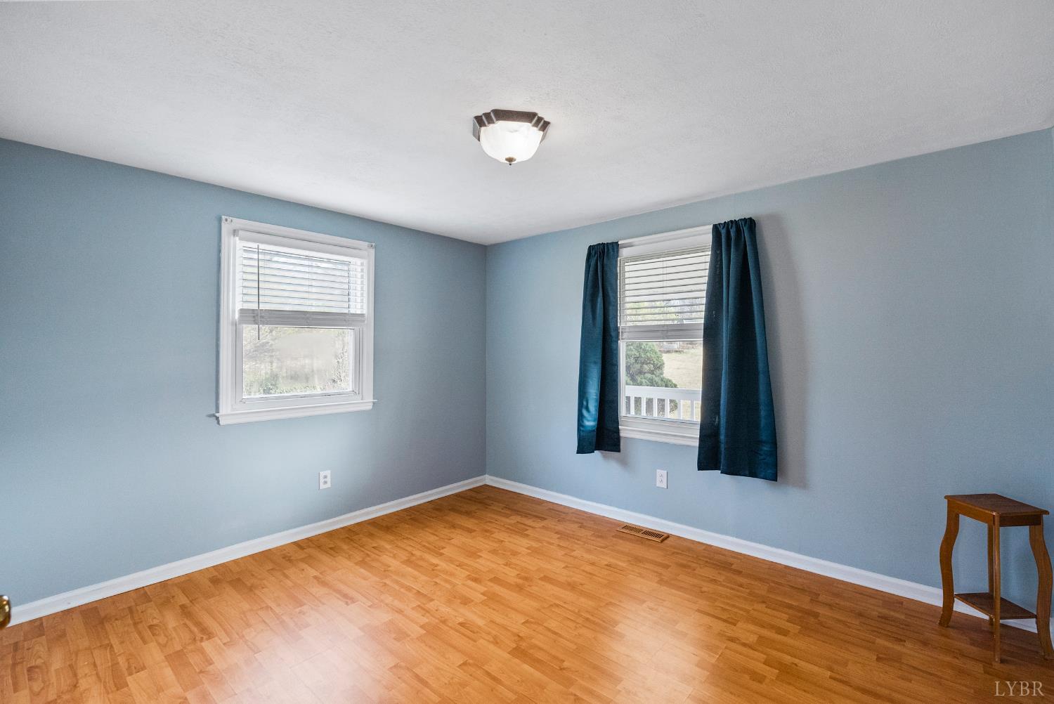 997 Toytown Road Amherst, VA 24521 - Photo 17 of 50 a view of an empty room with wooden floor and a window