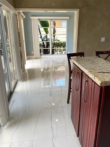 a view of a living room and floor to dining room