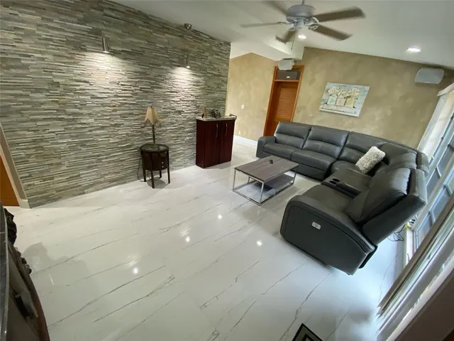 a view of living room with furniture and a fireplace