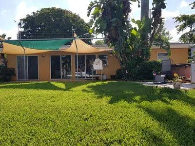 a front view of a house with garden and sitting area