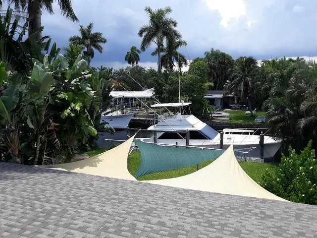 a view of a swimming pool with a patio and a yard