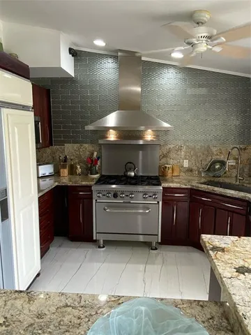 a kitchen with a sink and stainless steel appliances