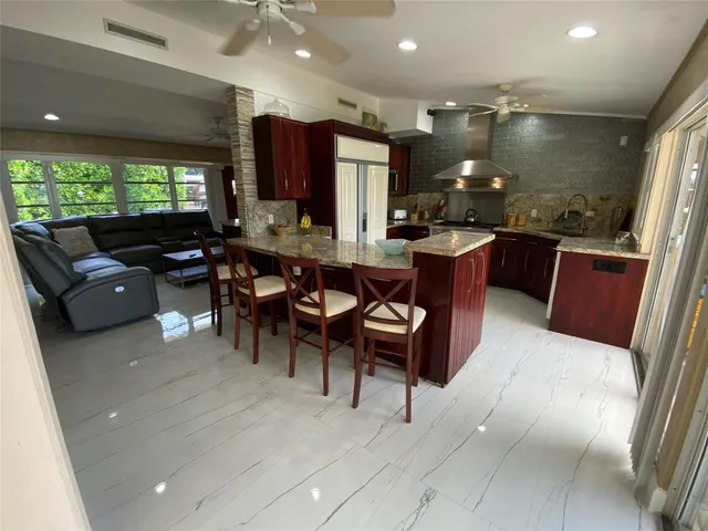 a living room with lots of furniture and kitchen view