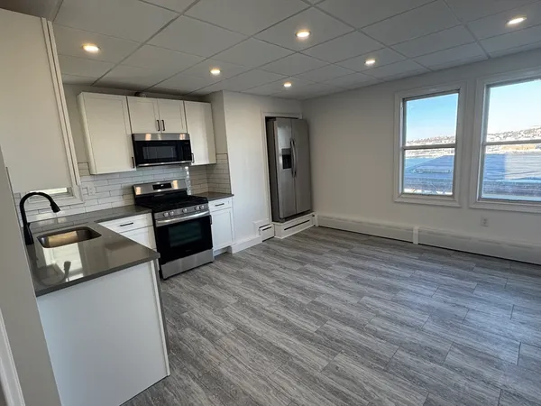 a view of a kitchen with a sink and a stove top oven