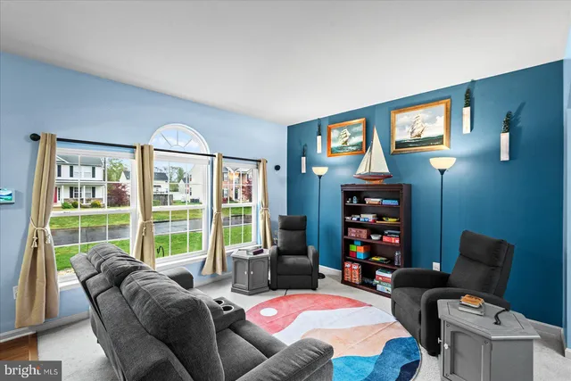 a view of a dining room with furniture and a chandelier