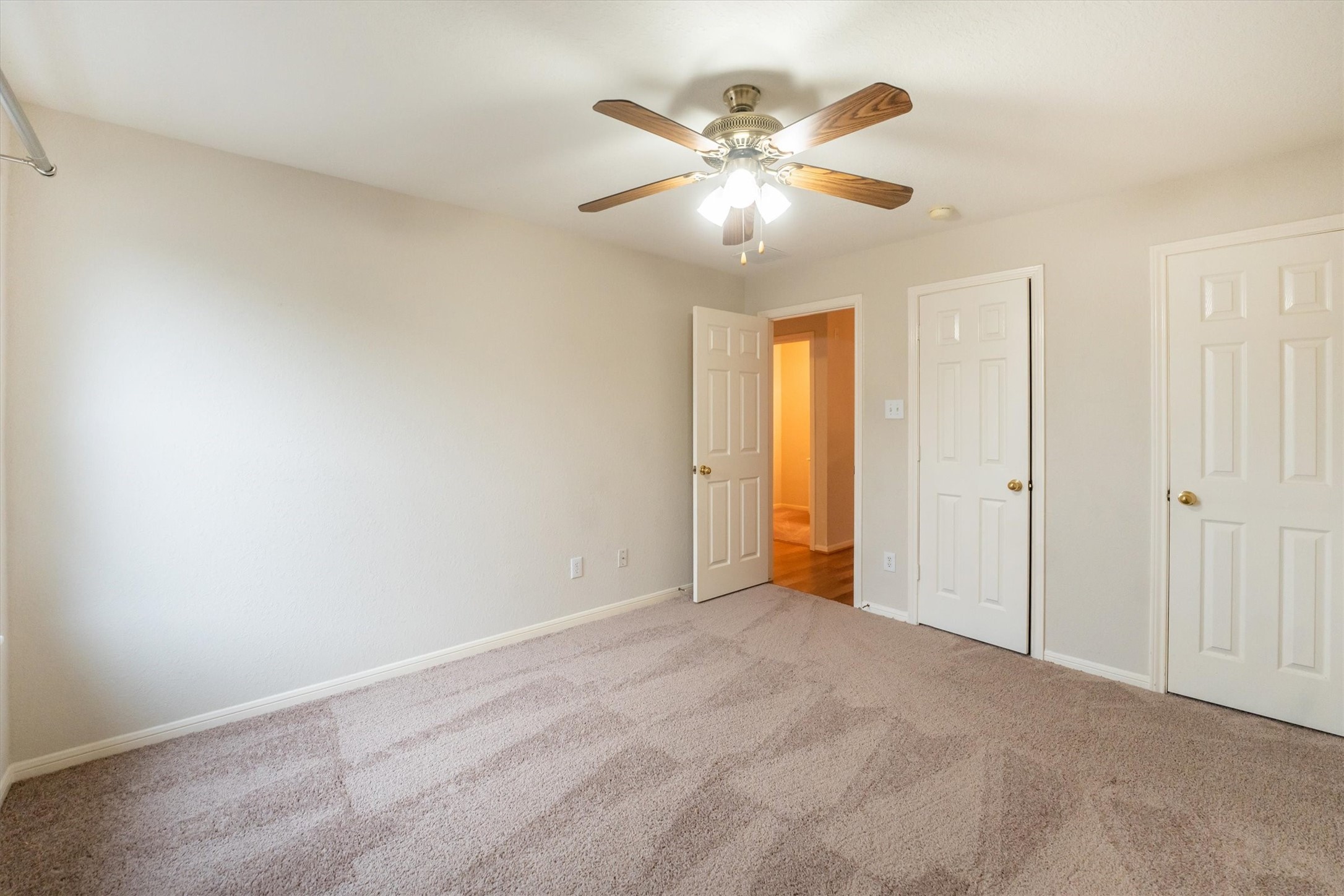 14626 Hazy Ridge Lane Cypress, TX 77429 - Photo 32 of 50 an empty room with closet and a chandelier fan