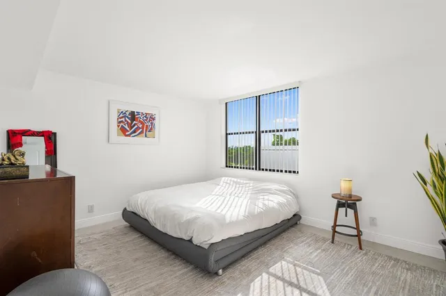 a bathroom with a granite countertop shower sink and mirror