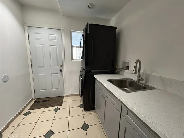 a kitchen with a sink and a refrigerator