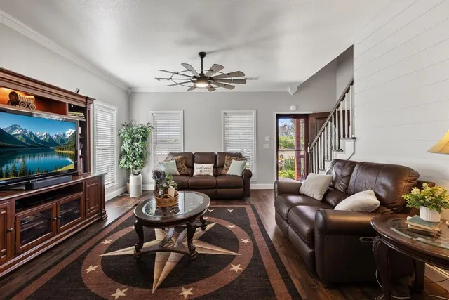a living room with furniture a fireplace and a flat screen tv