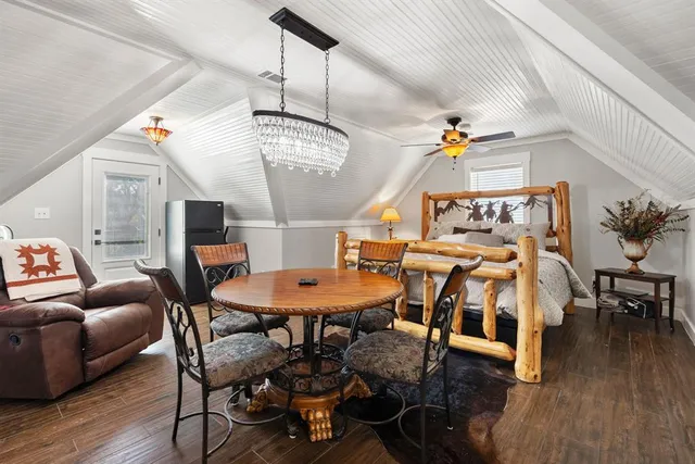 a view of a workspace with furniture and a ceiling fan