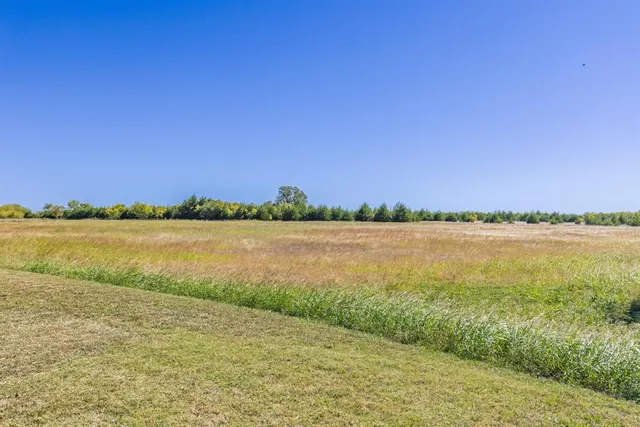 a view of a house with a flower garden