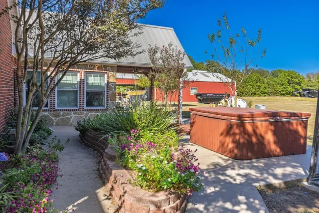 a view of a house with a flower garden