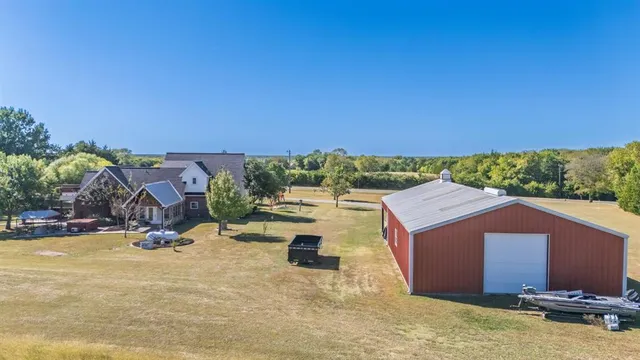 an aerial view of a house with yard swimming pool and outdoor seating