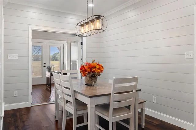 a dining room with furniture and chandelier
