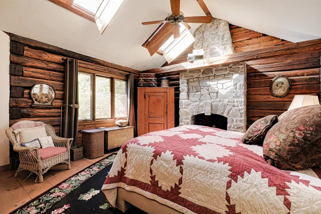 a bedroom with bed and a fireplace