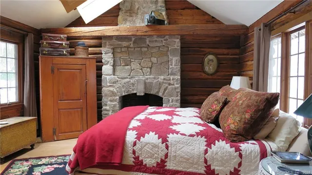 a bed room with a bed and a chair