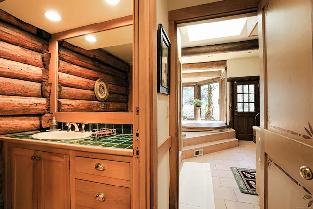 a living room with fireplace furniture and a floor to ceiling window