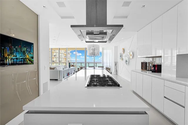 a kitchen with stainless steel appliances a sink a stove and a wooden floors