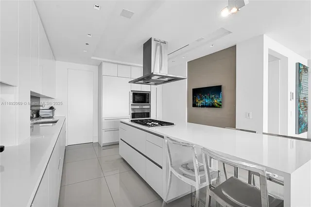 a spacious bedroom with a bed and a flat screen tv