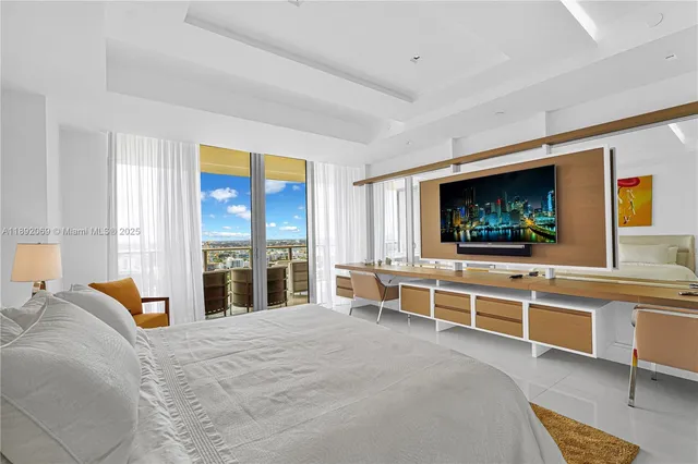 a bedroom with a bed and a flat screen tv