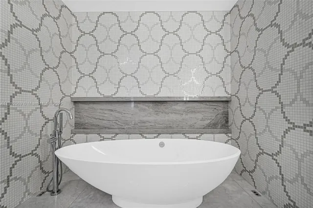 a living room with fireplace furniture and a large window