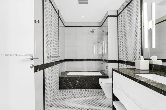 a bedroom with a bed and a flat tv screen