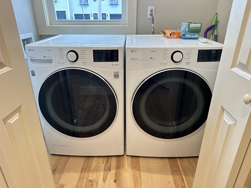 39 Snow Street, Unit SINGLE Boston, MA 02135 - Photo 12 of 28 a utility room with dryer and washer