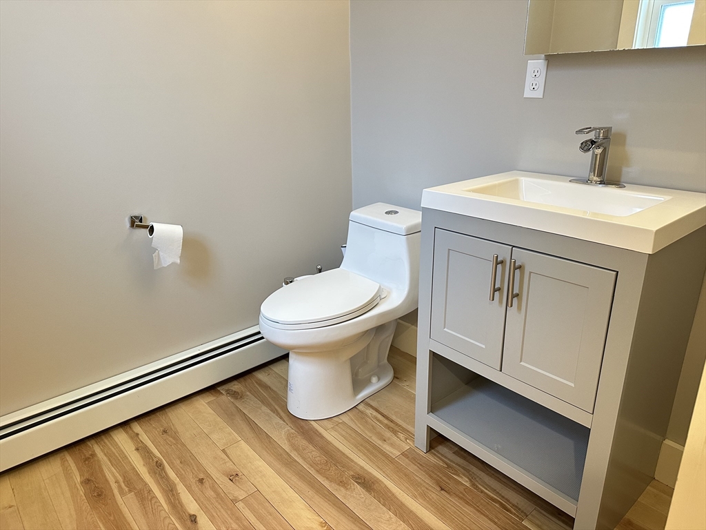 39 Snow Street, Unit SINGLE Boston, MA 02135 - Photo 16 of 28 a white toilet sitting next to a bathroom sink