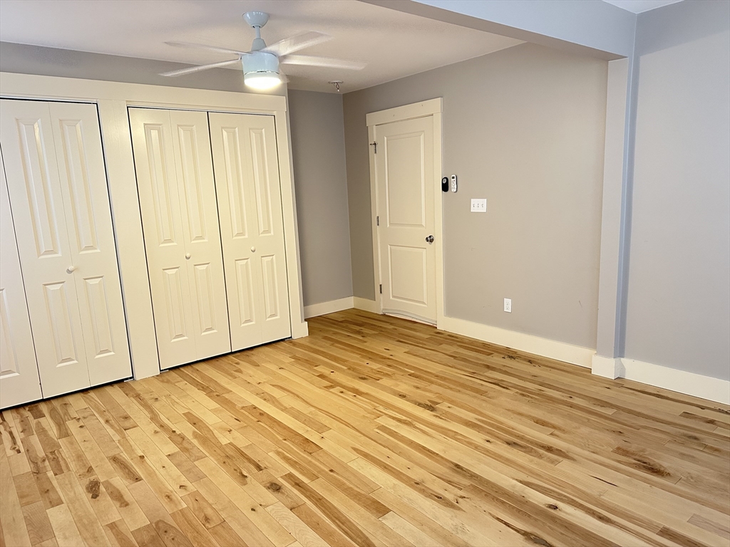 39 Snow Street, Unit SINGLE Boston, MA 02135 - Photo 20 of 28 a view of an empty room with wooden floor