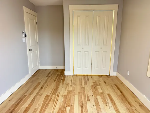 a view of a room with wooden floor and bathroom
