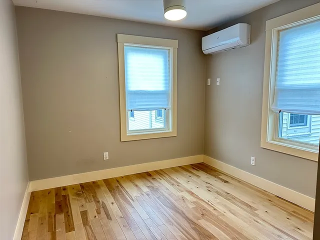 a view of a room with wooden floor and window