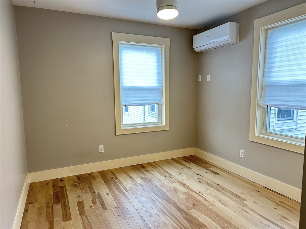 39 Snow Street, Unit SINGLE Boston, MA 02135 - Photo 27 of 28 a view of a room with wooden floor and window