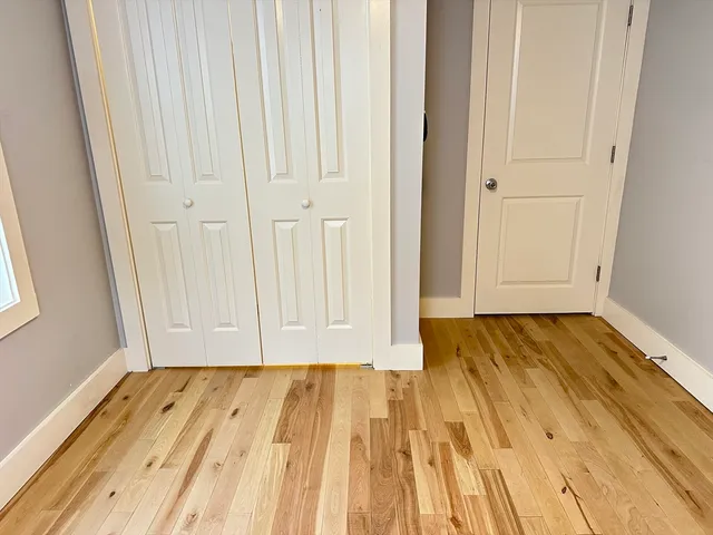 a view of a room with wooden floor