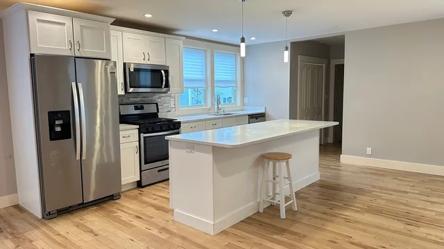 a kitchen with wooden cabinets and stainless steel appliances