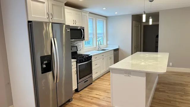 a kitchen with stainless steel appliances a refrigerator and a stove