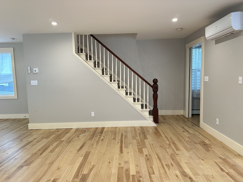 39 Snow Street, Unit SINGLE Boston, MA 02135 - Photo 8 of 28 a view of a hallway with wooden floor