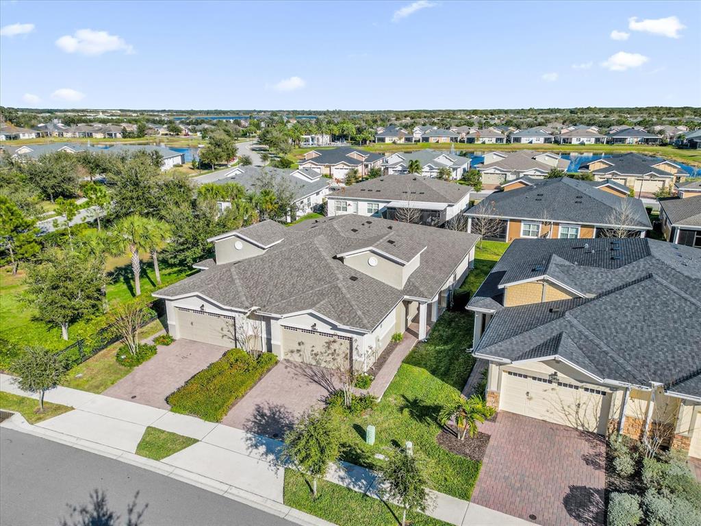 an aerial view of residential houses with outdoor space and ocean view