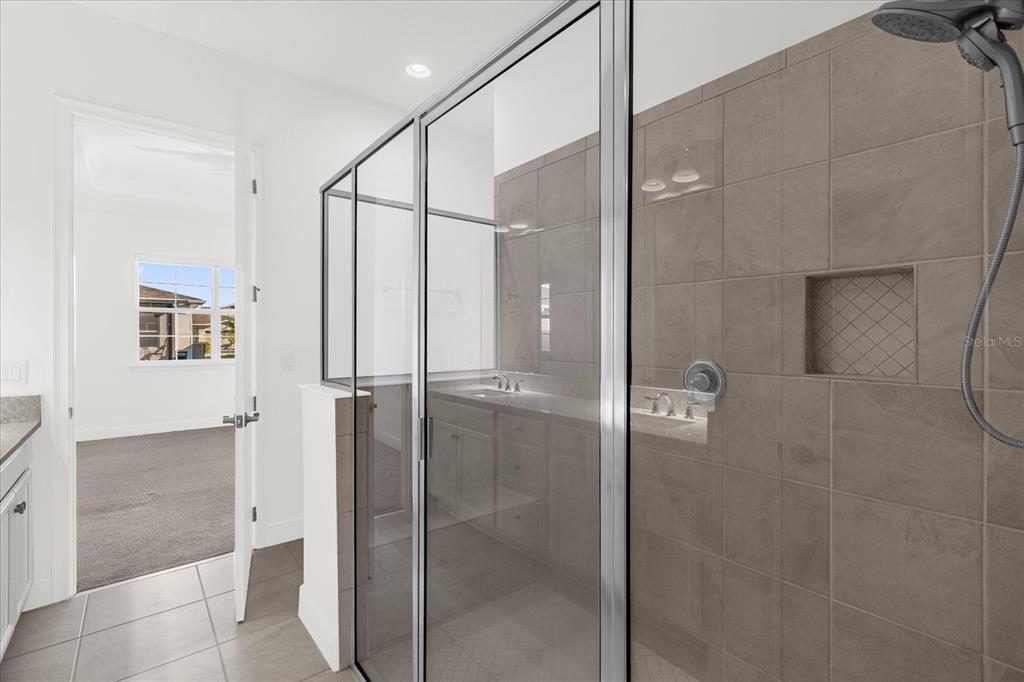 2360 Datura Loop St. Cloud, FL 34772 - Photo 11 of 46 a bathroom with a shower and a glass door