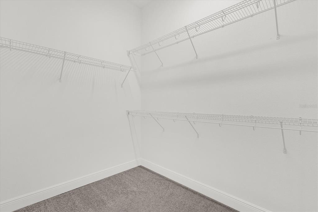 2360 Datura Loop St. Cloud, FL 34772 - Photo 12 of 46 a view of a room with racks on the wall