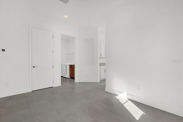 a utility room with a sink and washing machine