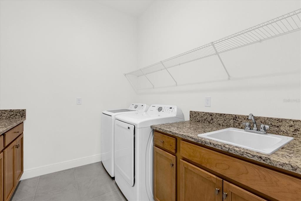 2360 Datura Loop St. Cloud, FL 34772 - Photo 17 of 46 a utility room with a sink and washing machine