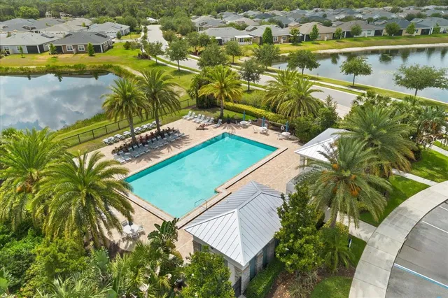 an aerial view of a house with a swimming pool outdoor seating and yard