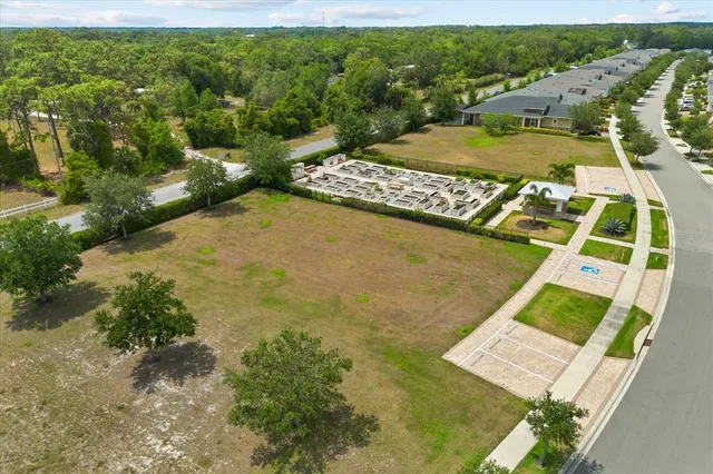 an aerial view of ocean and residential building with outdoor space