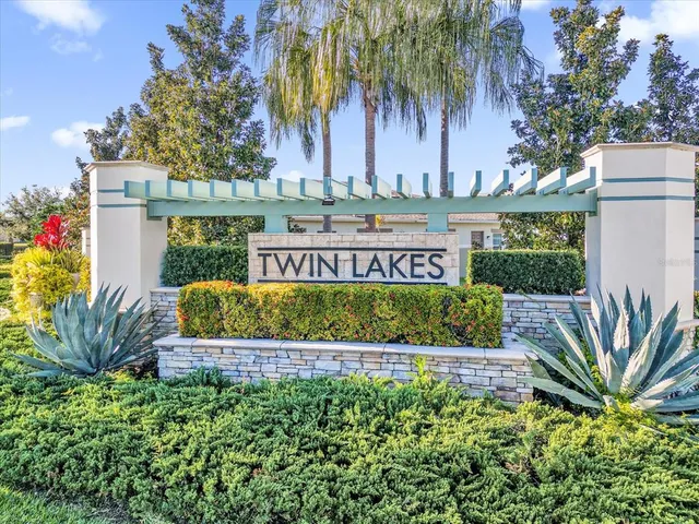 a view of a house with a yard and potted plants